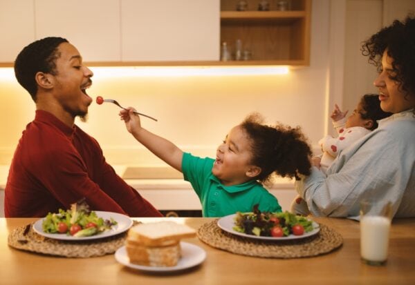 happy father and daughter eating healthy food